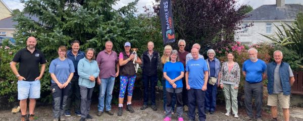 A group of Camarthernshire Ramblers stood together smiling to camera